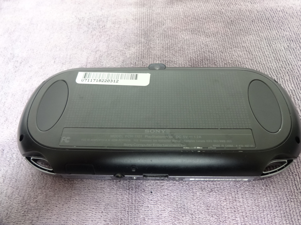 The back of the Vita with some grime and smudges on it.